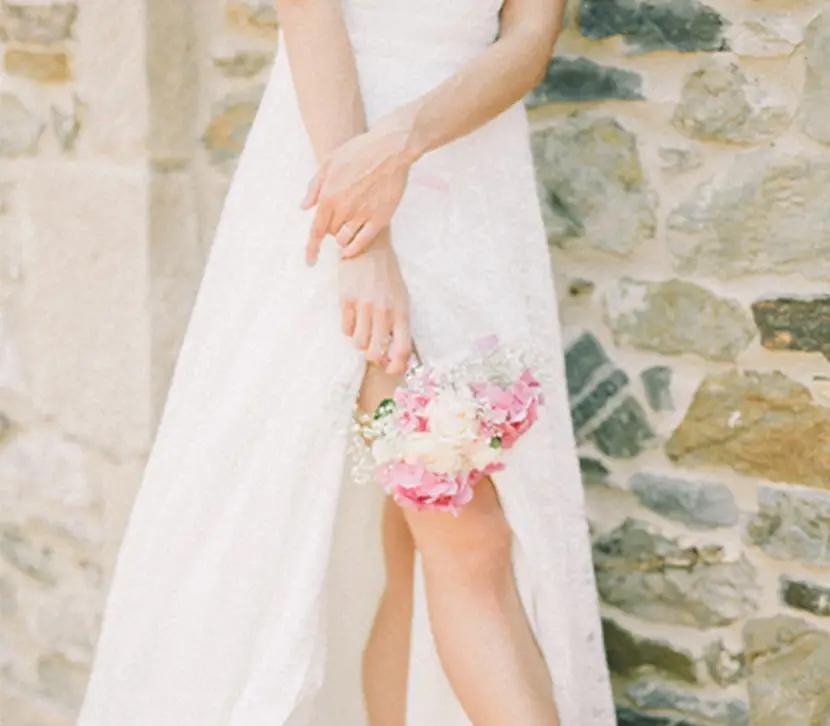 Bride wearing a white gown holding a flower bouquet