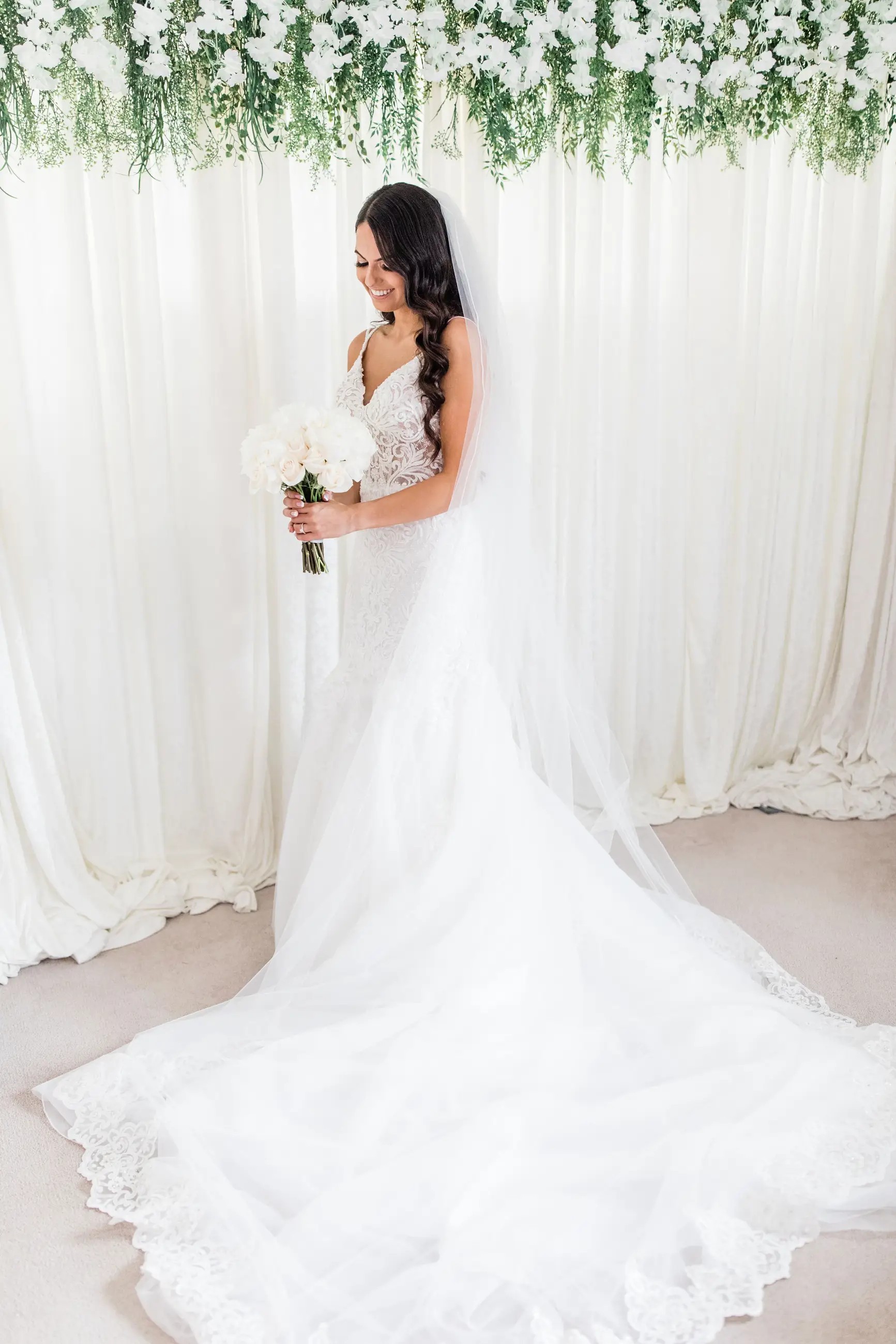 Bride posing for a picture looking down