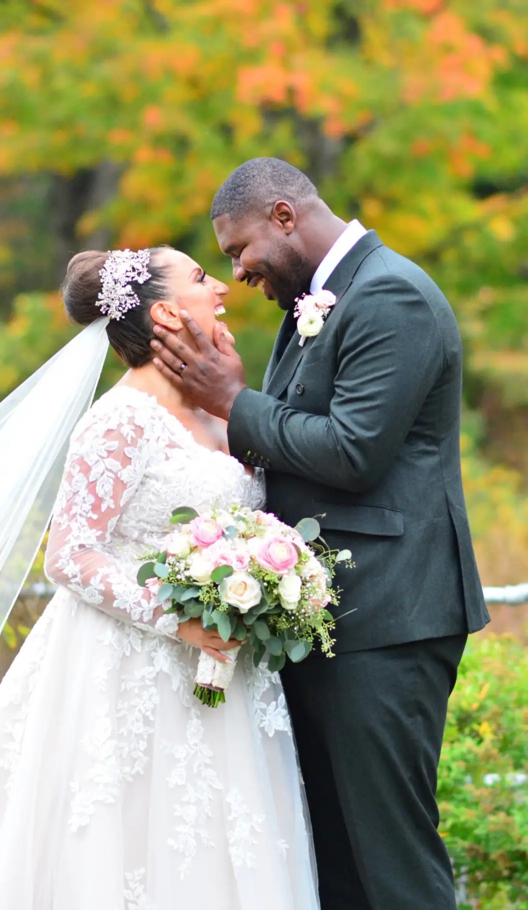 Bride and groom smiling as they stare into each others eyes